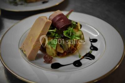 Plateaux de bouchées apéritives variées disposés sur des supports en bois dans un cadre extérieur.