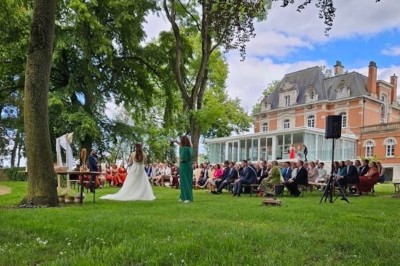 Miniature Location salle Sailly-sur-la-Lys (Pas-de-Calais) - Le Chateau de Bac Saint Maur #23 Cérémonie en plein air dans un parc, avec des invités assis face à une mariée et un officiant, devant un manoir.