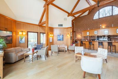 Miniature Location salle Janvry (Essonne) - Golf de Marivaux #6 Maison en bois éclairée la nuit, entourée d'arbres illuminés, sous un ciel nuageux avec la lune visible.