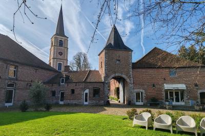 Miniature La Gentilhommière Un vélo ancien posé près de caisses en bois et d'objets décoratifs dans un jardin verdoyant.