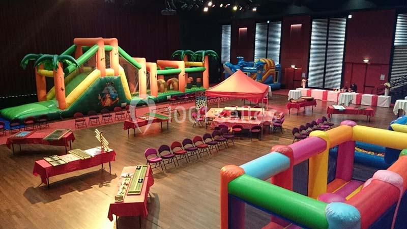 Location salle La Grande-Motte (Hérault) - Pasino de la Grande Motte #9 Salle avec structures gonflables colorées, tables, chaises et stands installés pour un événement intérieur.