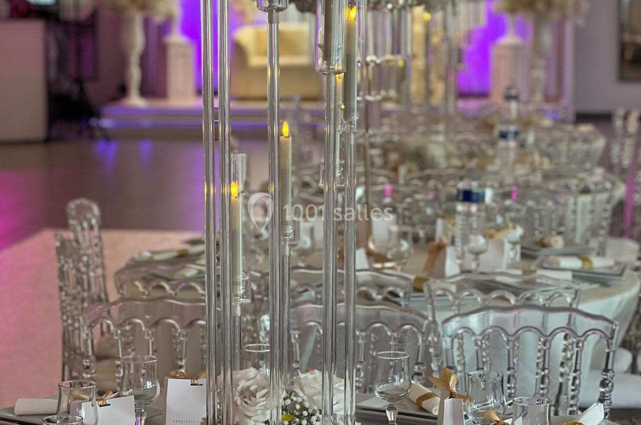 Location salle Beauchamp (Val-d'Oise) - Les Salons Beauchamp #45 Table de réception élégamment décorée avec chandeliers, fleurs blanches et détails dorés dans une salle lumineuse.