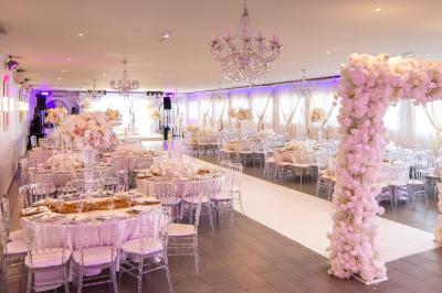 Miniature Location salle Beauchamp (Val-d'Oise) - Les Salons Beauchamp #2 Salle de réception élégante avec tables décorées de fleurs blanches, chaises transparentes et éclairage tamisé.