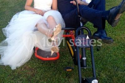 Miniature Location salle Vignieu (Isère) - Domaine de Suzel #20 Chambre avec lit rond, couverture rouge, pétales de rose, lampe de chevet et plafond en bois avec suspension plumeuse.