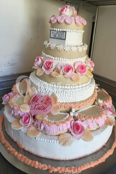 Location salle Vignieu (Isère) - Domaine de Suzel #10 Gâteau de mariage à plusieurs étages décoré de fleurs roses, de perles en sucre et de motifs en crème.