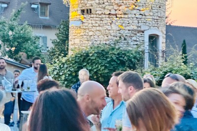 Miniature Location salle Vignieu (Isère) - Domaine de Suzel #49 Chambre avec lit rond, couverture rouge, pétales de rose, lampe de chevet et plafond en bois avec suspension plumeuse.