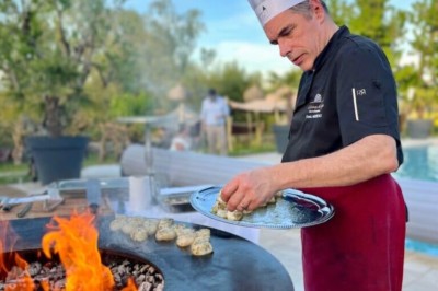 Un couple de dos regarde un feu d'artifice illuminer le ciel nocturne dans un cadre extérieur.