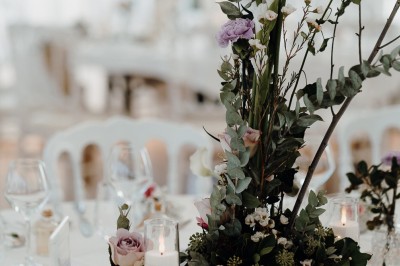 Un couple de dos regarde un feu d'artifice illuminer le ciel nocturne dans un cadre extérieur.