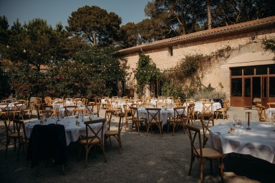 Miniature Location salle Montagnac (Hérault) - Domaine de la Grangette #15 Tente en toile beige installée sur un sol gravillonné, entourée d'arbres, avec des lits aménagés à l'intérieur.