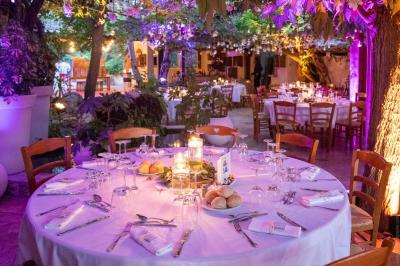 Miniature Location salle Gémenos (Bouches-du-Rhône) - Moulin de Gemenos #4 Salle de réception avec tables rondes dressées, nappes blanches, chaises en bois et décoration florale.