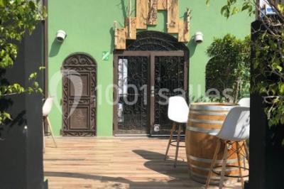 Miniature Location salle Vallauris (Alpes-Maritimes) - L'Adresse #9 Terrasse extérieure avec tables dressées, chaises en métal ajouré, plantes et pergola partiellement couverte.