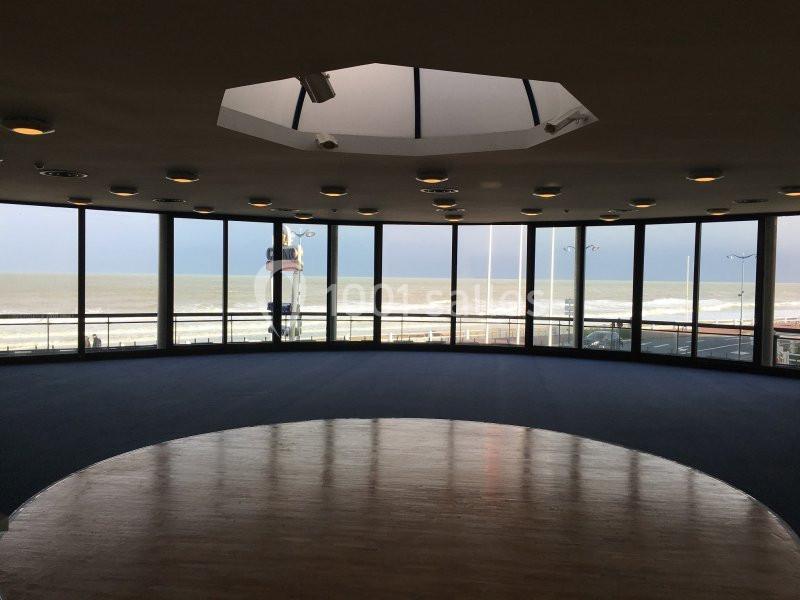 Location salle Villers-sur-Mer (Calvados) - Salle Panoramique Villers Sur Mer #2 Salle circulaire avec de grandes baies vitrées offrant une vue sur la mer et une promenade en bord de plage.