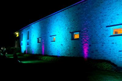 Deux réfrigérateurs professionnels vides dans une pièce carrelée avec une table en inox au premier plan.