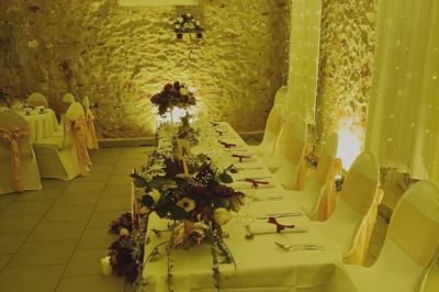 Deux réfrigérateurs professionnels vides dans une pièce carrelée avec une table en inox au premier plan.