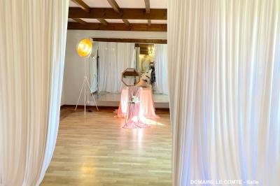 Table élégamment dressée avec vaisselle blanche et décorations florales, donnant sur une piste équestre en arrière-plan.