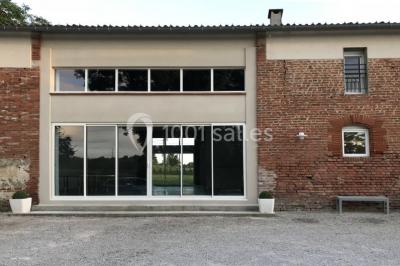 Deux lits simples avec housses rouges à pois blancs dans une chambre lumineuse décorée de touches rouges et blanches.