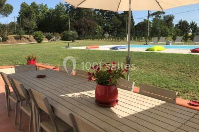 Deux lits simples avec housses rouges à pois blancs dans une chambre lumineuse décorée de touches rouges et blanches.