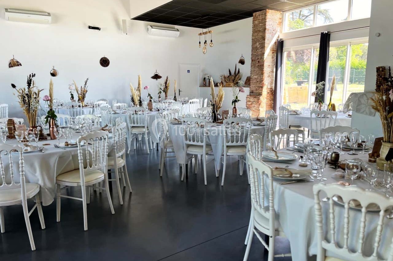 Location salle Sainte-Foy-d'Aigrefeuille (Haute-Garonne) - Les Ecuries de Ronsac #3 Salle de réception décorée avec des tables rondes dressées, nappes blanches et éléments naturels.