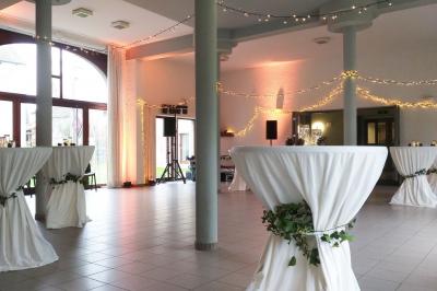 Vue aérienne d'un complexe avec plusieurs bâtiments, un jardin central, un parking et des zones identifiées par des noms.