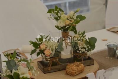 Miniature Location salle Beaudéduit (Oise) - LFK Réceptions #15 Pièce montée en forme d'anneaux entrelacés avec des figurines de mariés, entourée de bouteilles de champagne.