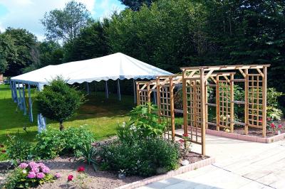 Miniature Barnum pour la cérémonie laïque Pièce montée en forme d'anneaux entrelacés avec des figurines de mariés, entourée de bouteilles de champagne.