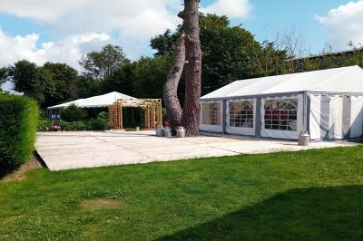 Miniature Terrasse de 110m² pour votre vin d'honneur Pièce montée en forme d'anneaux entrelacés avec des figurines de mariés, entourée de bouteilles de champagne.