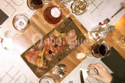 Miniature Location salle Fampoux (Pas-de-Calais) - L'hermitage de Fampoux #8 Salle sombre avec éclairage violet, plafond métallique, tables et chaises dispersées sur un sol à carreaux.