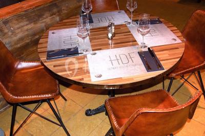 Miniature Location salle Fampoux (Pas-de-Calais) - L'hermitage de Fampoux #11 Salle sombre avec éclairage violet, plafond métallique, tables et chaises dispersées sur un sol à carreaux.