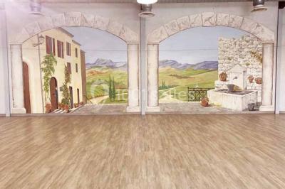 Table de pique-nique en bois sur un sol de gravier, entourée d'arbres dans un cadre naturel.