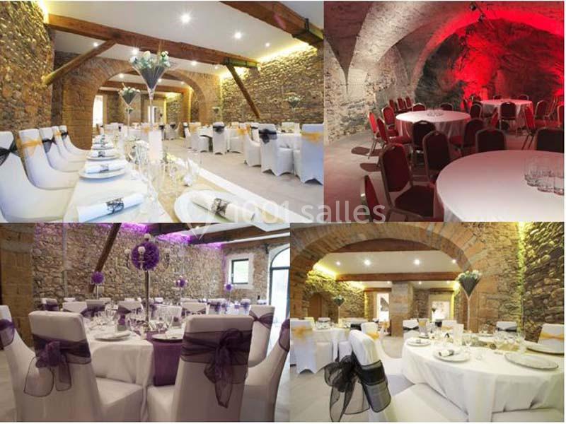 Salle de réception en pierre avec tables décorées pour un événement, éclairage chaleureux et ambiance élégante.