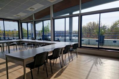 Miniature Location salle Rouen (Seine-Maritime) - Union Portuaire Rouennaise #2 Parking extérieur avec quelques voitures stationnées, entouré de bâtiments modernes et d'arbres alignés.