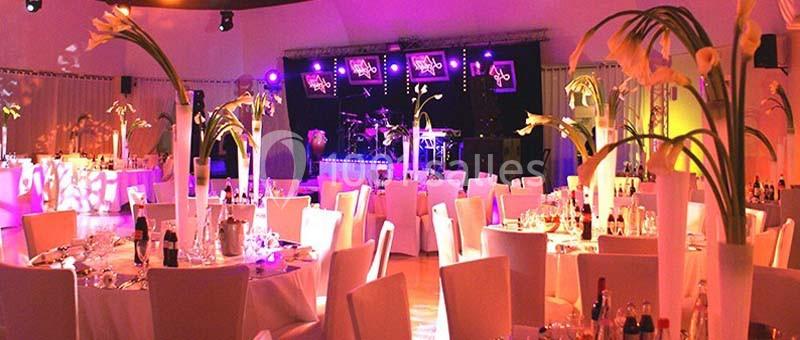 Location salle Rueil-Malmaison (Hauts-de-Seine) - Paris Country Club #7 Salle de réception décorée avec des tables rondes, des chaises blanches et des arrangements floraux, éclairée par des…