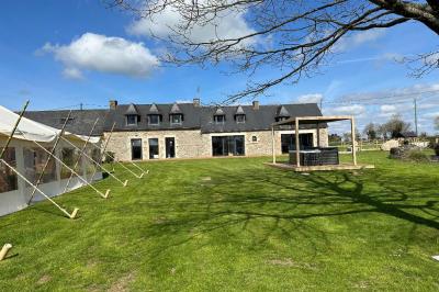 Miniature Location salle Rostrenen (Côtes-d'Armor) - Domaine Un Jour Parfait #6 Chambre moderne avec mur vert, lit double décoré de coussins, luminaires muraux et tapis clair au sol.