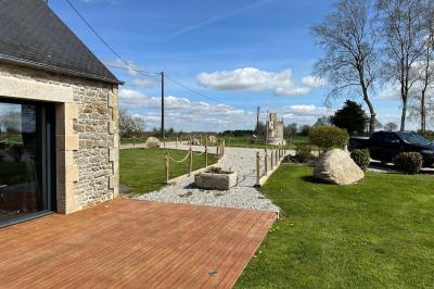 Miniature Location salle Rostrenen (Côtes-d'Armor) - Domaine Un Jour Parfait #11 Chambre moderne avec mur vert, lit double décoré de coussins, luminaires muraux et tapis clair au sol.