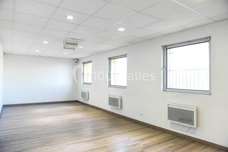 Location salle Hénin-Beaumont (Pas-de-Calais) - Team Square Events #12 Salle vide avec parquet, murs blancs, plafond à dalles, fenêtres et climatiseurs muraux.