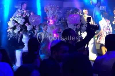 Parking extérieur avec plusieurs voitures stationnées, entouré d'arbres et offrant une vue dégagée au loin.