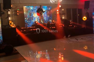 Parking extérieur avec plusieurs voitures stationnées, entouré d'arbres et offrant une vue dégagée au loin.