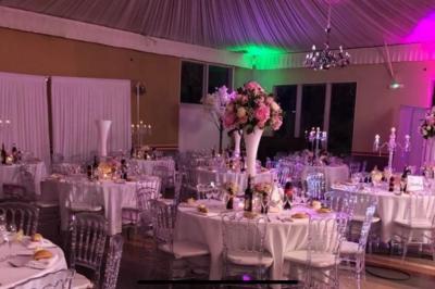 Parking extérieur avec plusieurs voitures stationnées, entouré d'arbres et offrant une vue dégagée au loin.