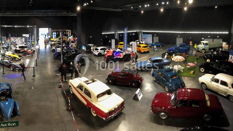 Location salle Dammarie-les-Lys (Seine-et-Marne) - Espace Pierre Bachelet #20 Vue d'une exposition intérieure de voitures anciennes et modernes, avec des visiteurs observant les véhicules.