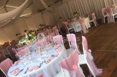 Miniature Location salle Dammarie-les-Lys (Seine-et-Marne) - Le Domaine du Lys #15 Décoration de salle de réception avec éclairage rose, rideaux, chandeliers et ornements lumineux en forme de cœur.