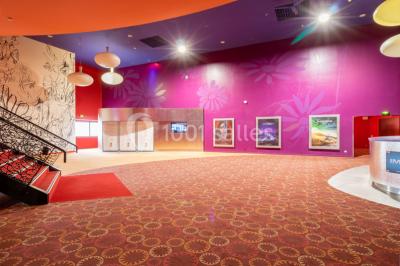Miniature Location salle Champs-sur-Marne (Seine-et-Marne) - Pathé Disney Village #6 Salle de cinéma vide avec des rangées de sièges rouges, éclairage tamisé et écran en fond.