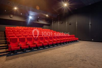 Miniature Location salle Levallois-Perret (Hauts-de-Seine) - Pathé Levallois #16 Salle de cinéma vide avec rangées de fauteuils rouges, éclairage tamisé et écran non visible à l'avant.