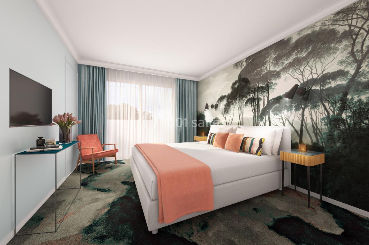Location salle Aix-en-Provence (Bouches-du-Rhône) - Hôtel Aquabella & Spa #20 Chambre lumineuse avec un lit double, un mur décoré de motifs forestiers, un fauteuil et une grande fenêtre avec rideaux.