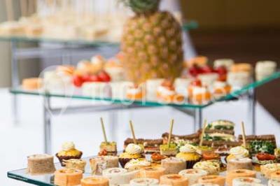 Dessert en forme de cœur au chocolat sur une assiette blanche, accompagné de coulis rouge et d'une verrine en arrière-plan.