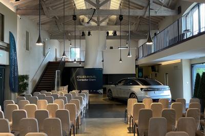 Montgolfière en cours de gonflage sur une pelouse, avec un manoir en arrière-plan et des arbres environnants.