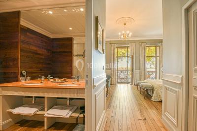 Montgolfière en cours de gonflage sur une pelouse, avec un manoir en arrière-plan et des arbres environnants.