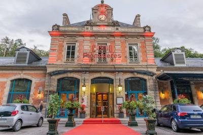 Salle de réception avec scène, piste de danse en bois, moquette rouge et plafond décoré d'une fresque.