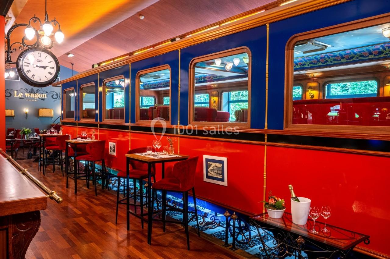 Le wagon du Restaurant Salle de restaurant décorée comme un wagon de train, avec tables dressées et ambiance chaleureuse.