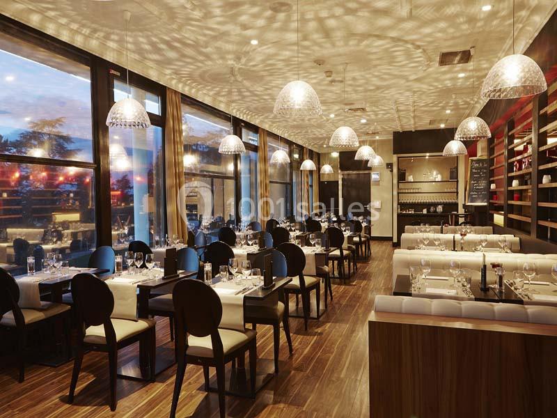 Location salle Saint-Galmier (Loire) - Casino de Saint-Galmier #10 Salle de restaurant élégante avec tables dressées, grandes baies vitrées et éclairage suspendu diffusant une lumière…