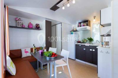 Miniature Location salle Hyères (Var) - La Réserve Hyères - Giens #26 Des personnes dansent en couple sur une piste éclairée par des lumières colorées, tandis que d'autres sont assises autour.